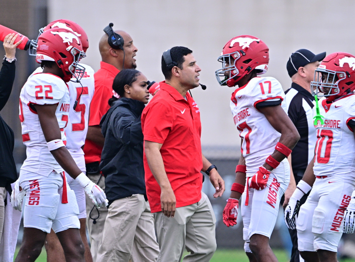 North Shore players, coaches meet on the sideline during a 6A Division I state semifinal win over Westlake on December 9.